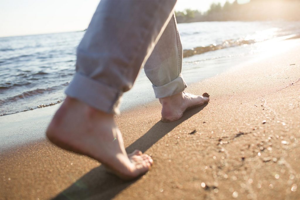Walking on the beach: 5 benefits of walking barefoot on the beach sand.